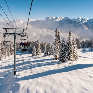 Skiers ride the lift up to the top of Purgatory Resort, in Colorado. The whole landscape is covered in powder.