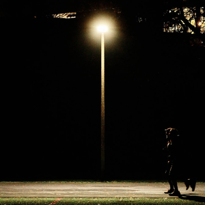 two runners running under a streetlamp