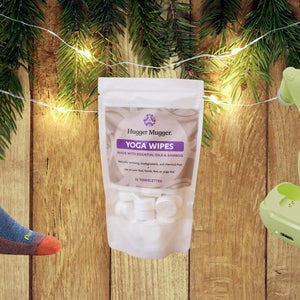 sock, bag of wipes, and earbuds on background with trees and lights