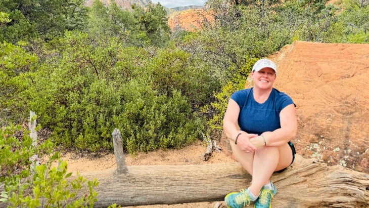 The author sitting on a log in Sedona’s Boynton Canyon