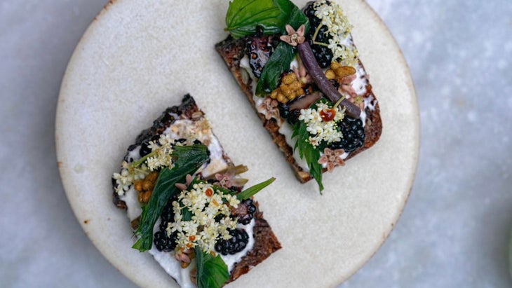 toast with berries and other wild ingredients on a white plate