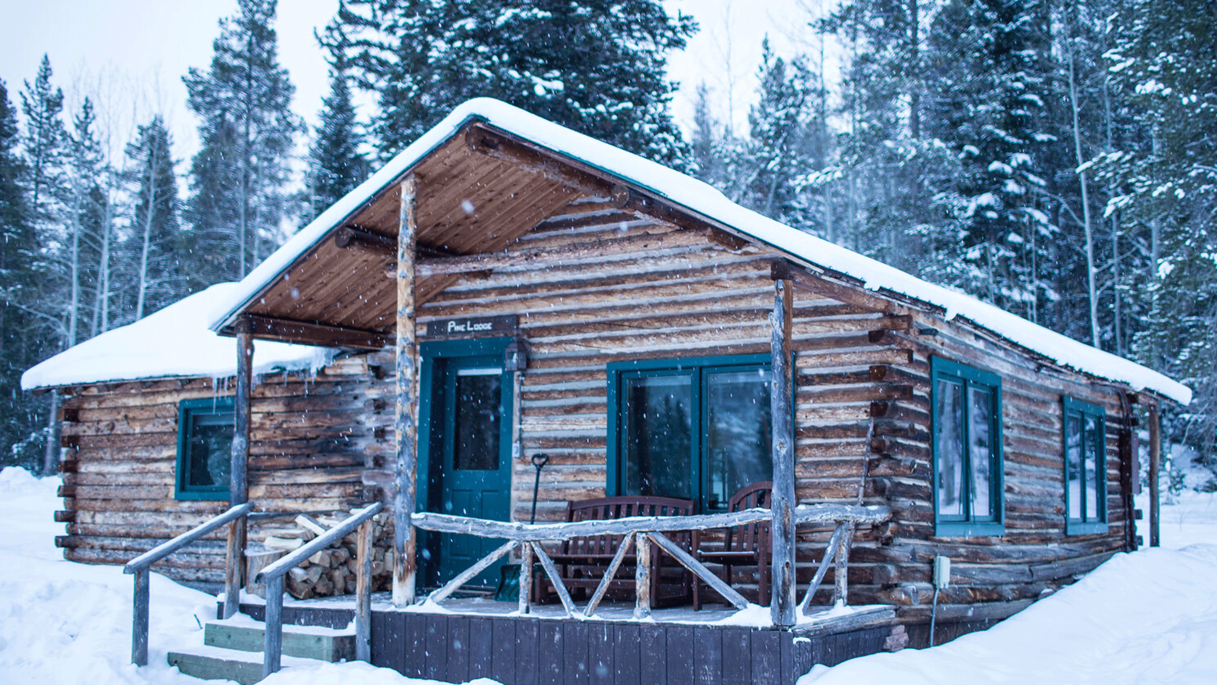 A log cabin covered in snow at Beyuls Retreats in Colorado