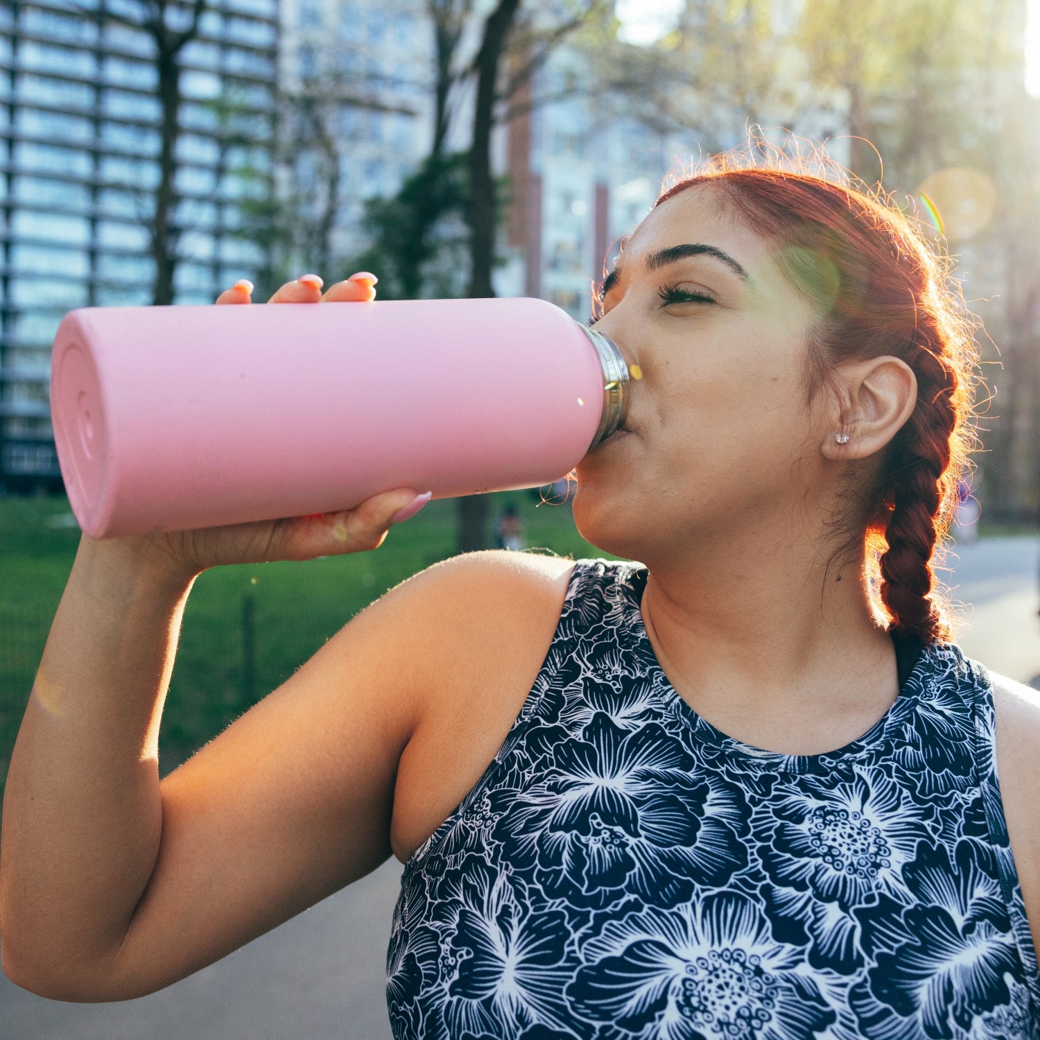 Woman drinking from a water bottle.