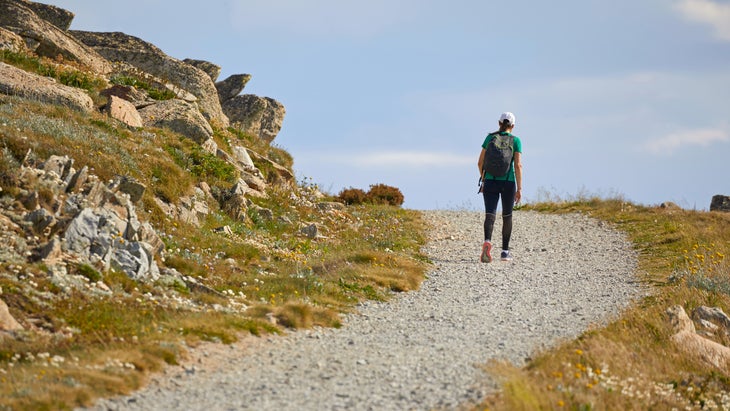 Woman rucking uphill on a rocky walking path