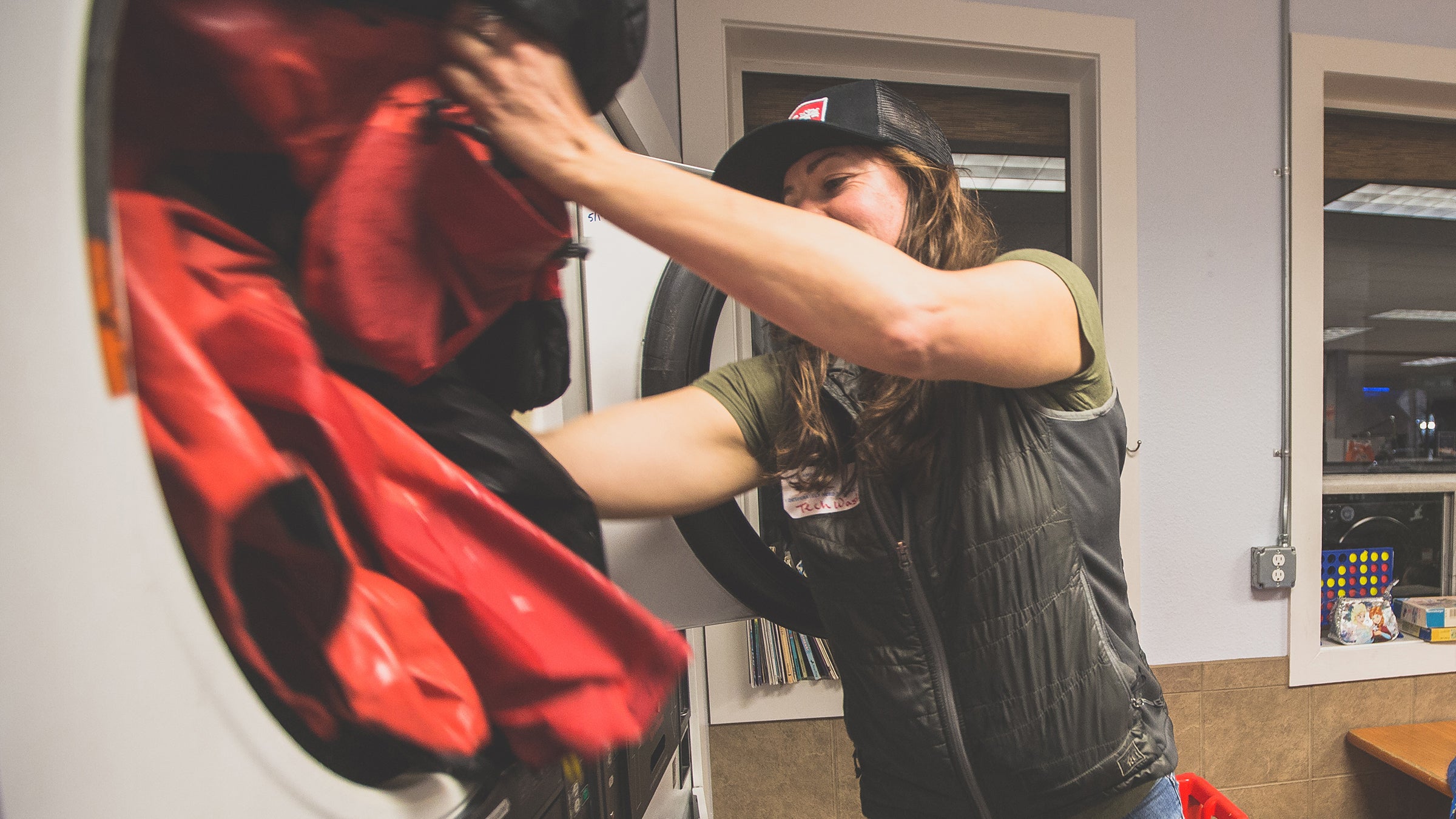 A woman waterproofing garments in the washing machine