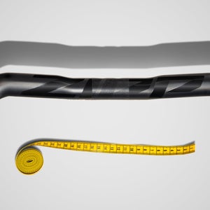 Zipp gravel handlebar with a tape measure in the background to demonstrate how gravel brands are failing women and small riders