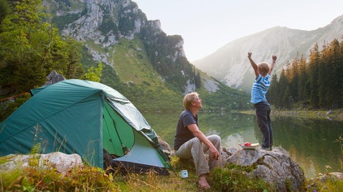 Father and son relaxing at campsite