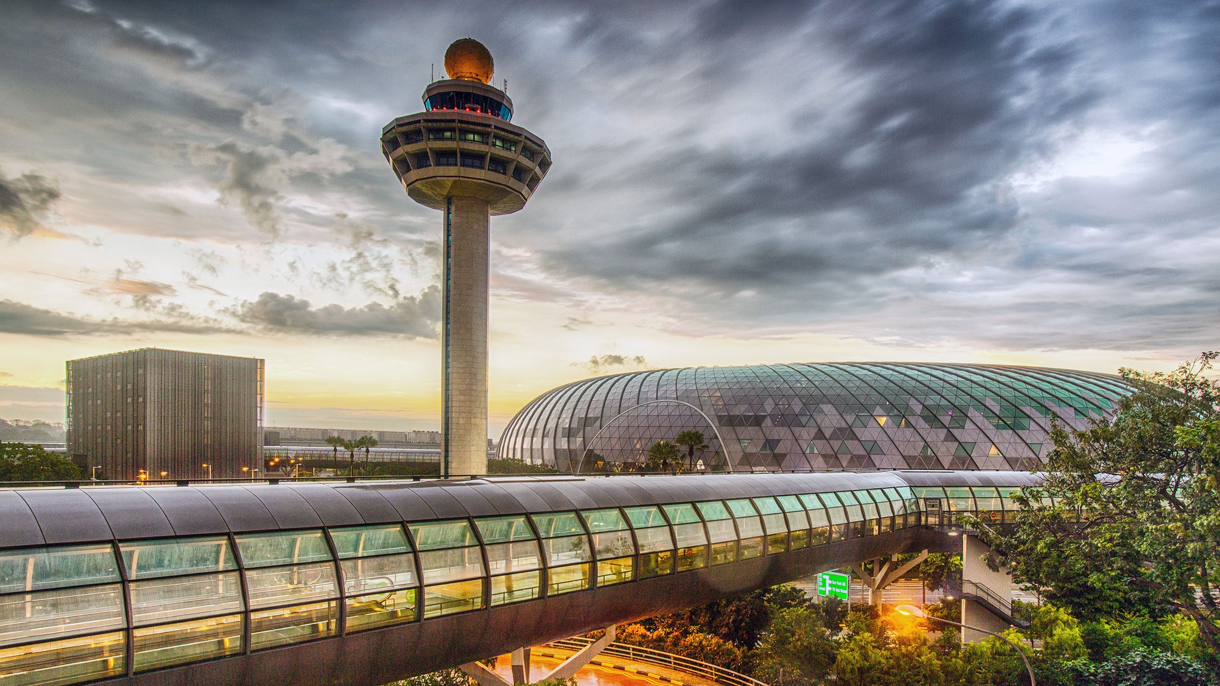 Singapore, Changi Airport, Terminal 2, passenger transit tunnel and control tower at dusk