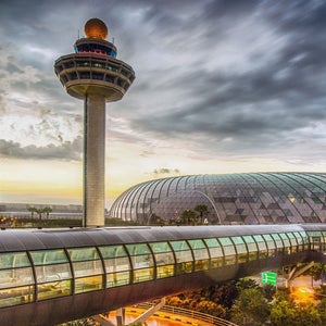 Singapore, Changi Airport, Terminal 2, passenger transit tunnel and control tower at dusk
