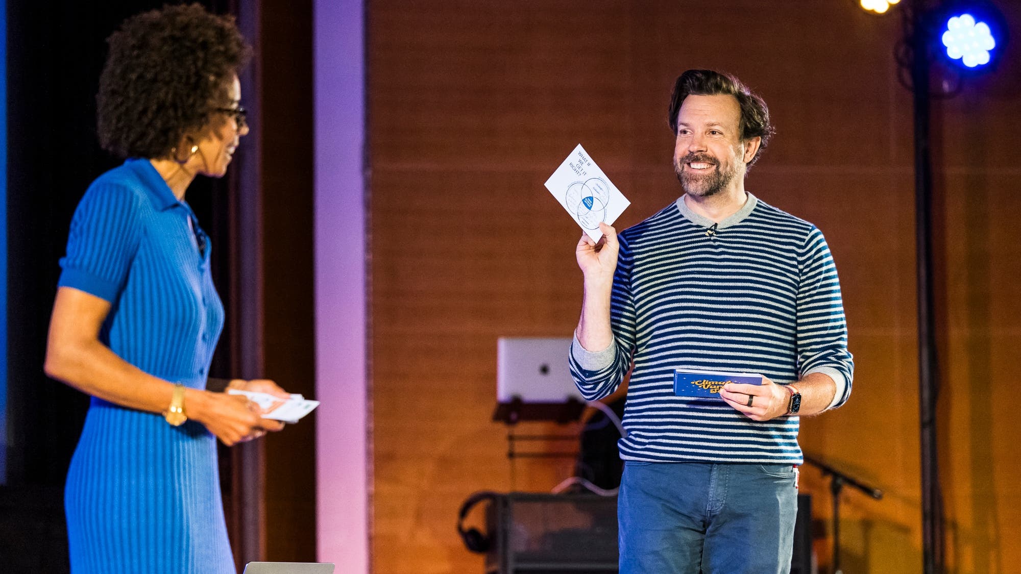 Jason Sudeikus and Ayana Elizabeth Johnson on stage at the Climate Variety Show during the What If We Get It Right? book tour