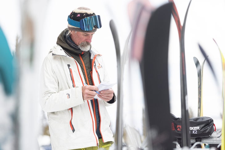 Skier filling out SKI Test scorecard while testing skis