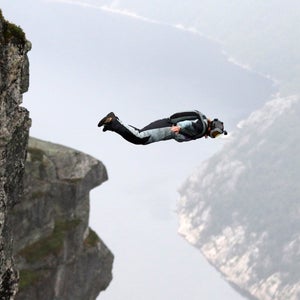 man jumping off of a cliff in Norway