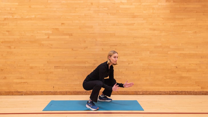 A woman in a deep squat