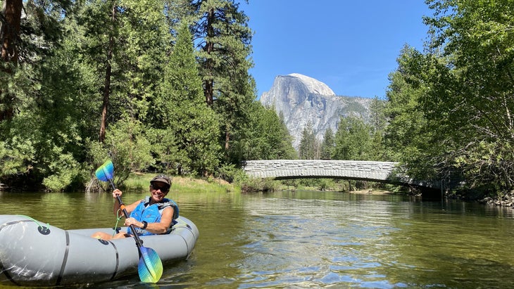 woman kayaking in Yosemite National Park, view of Half Dome