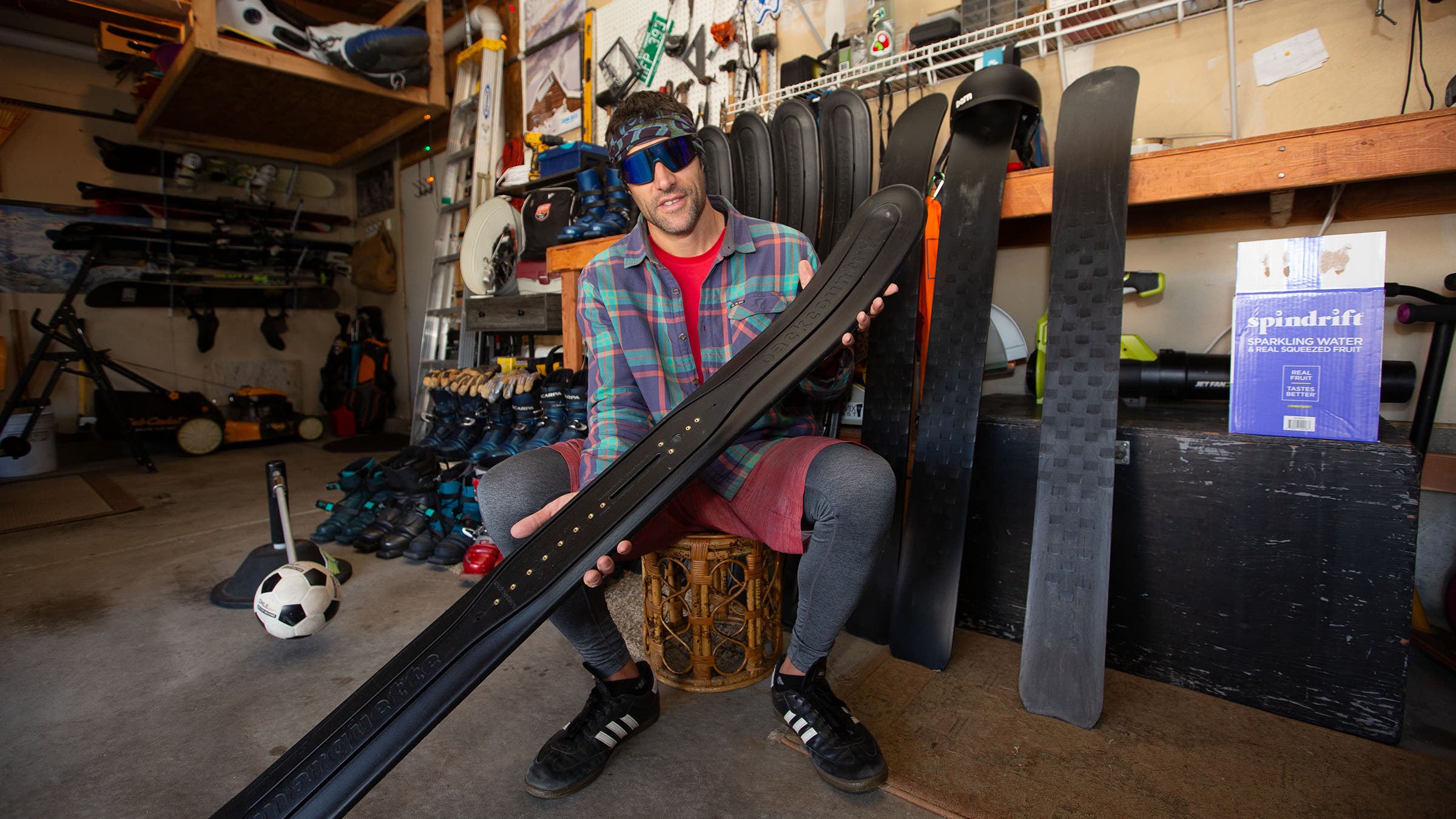 Showing off his fleet of Marquette Backcountry skis, which allow him to tour without skins