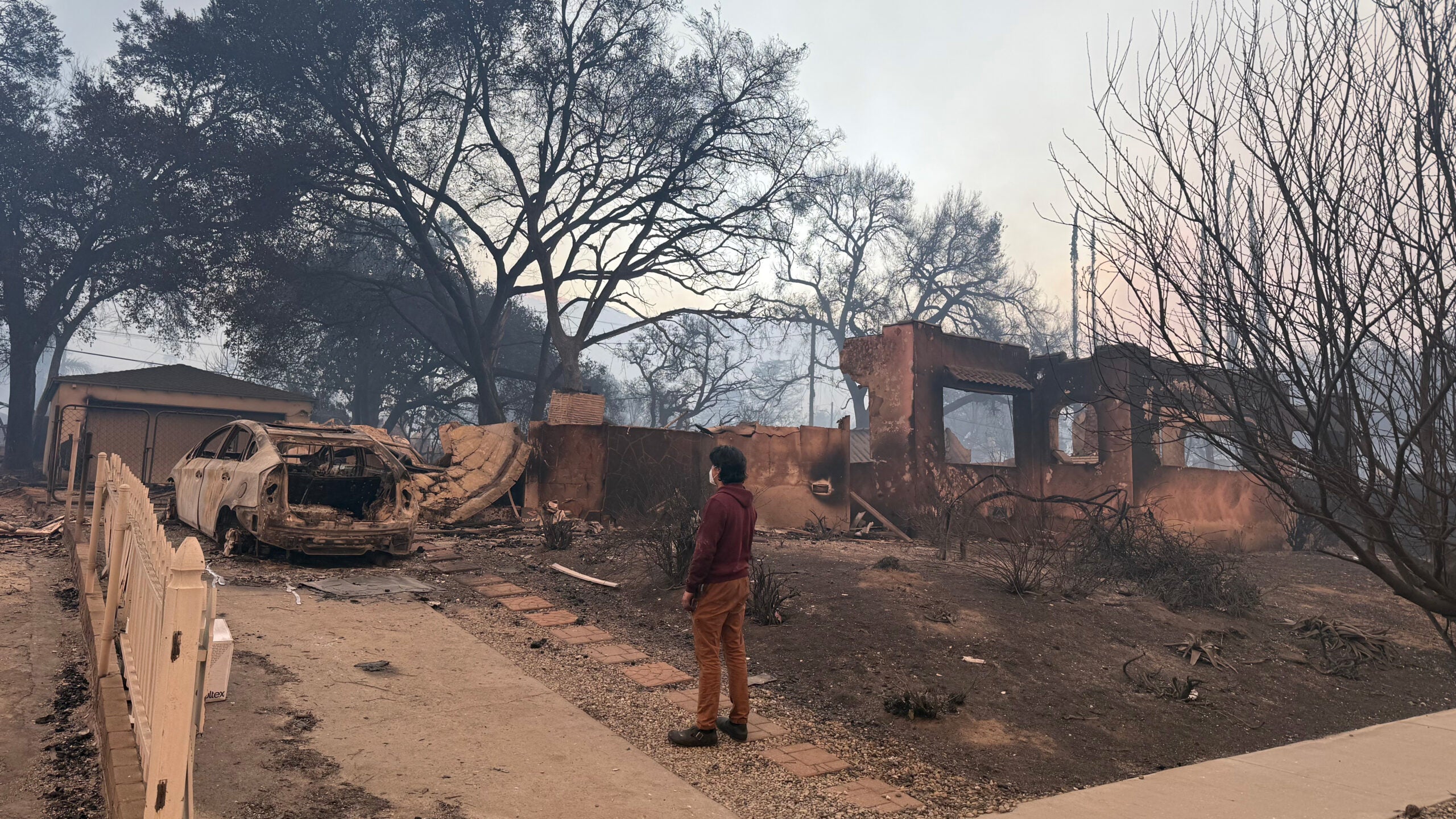 Andrew Goldner inspects the remains of his house