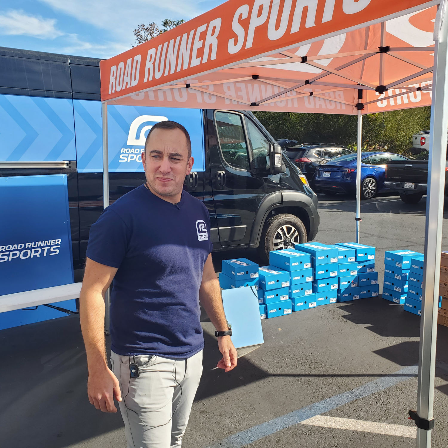 Aaron Olbur in front of his sprinter van full of shoes