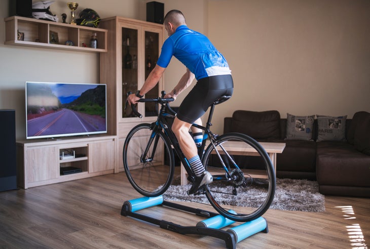 Man rides bike indoors on rollers