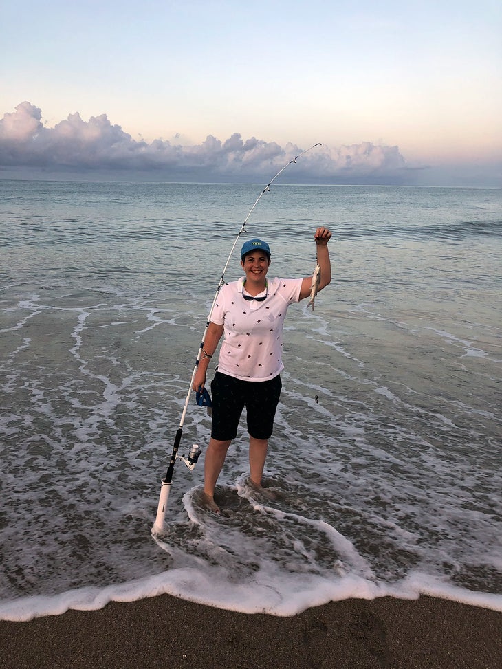 Mary-Frances Heck with a fishing pole and small fish caught off Vero Beach in Florida