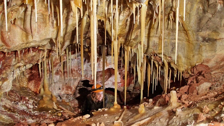 woman in helmet explores Wind Cave National Park, South Dakota.