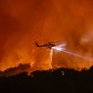 helicopter above bright red and orange sky
