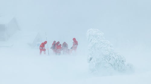 A group of rescuers aid a hypothermia victim.