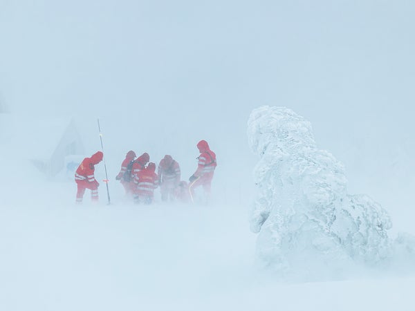 A group of rescuers aid a hypothermia victim.