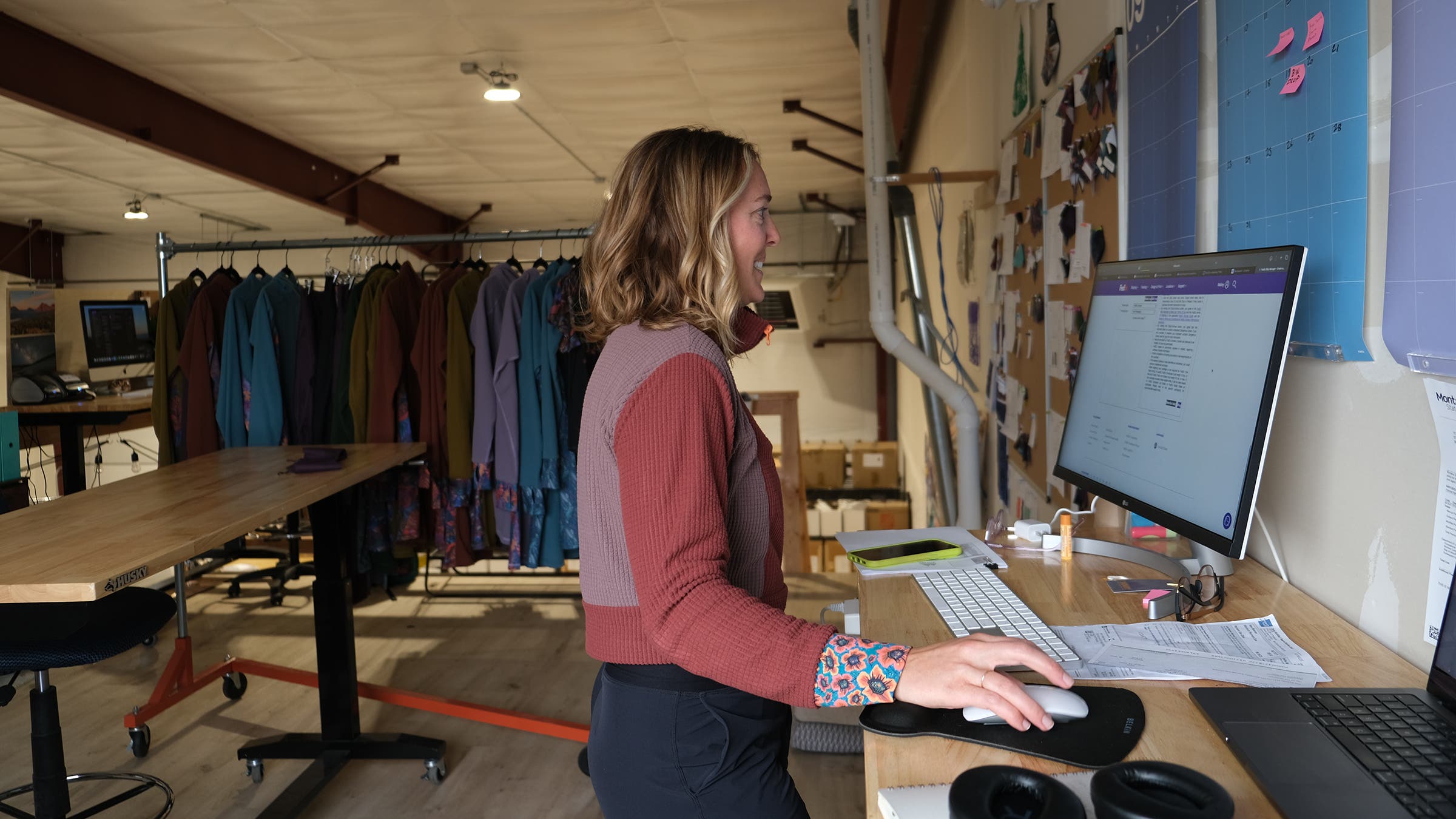 A woman works at her computer in an office