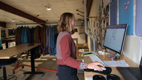 A woman works at her computer in an office