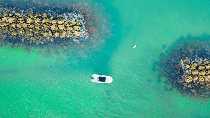 Aerial drone view of a ship in the sea in Marco Island at sunrise