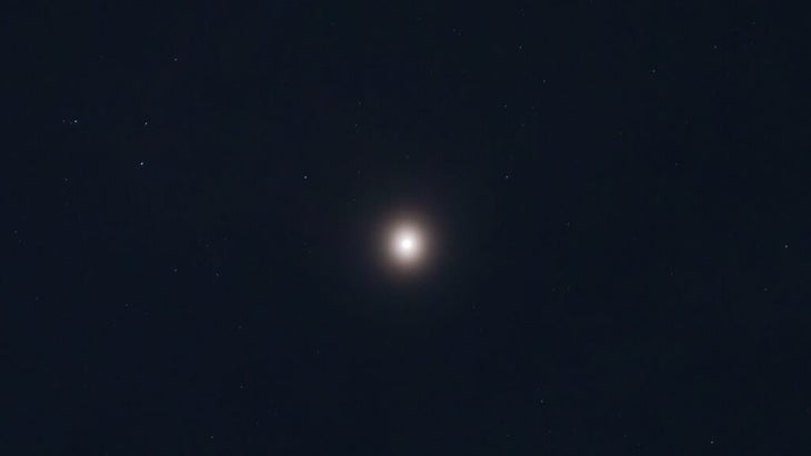 The author shot a photo of Mars at night from light-polluted San Diego and it's glowing very brightly amid the skycape and surrounding stars.