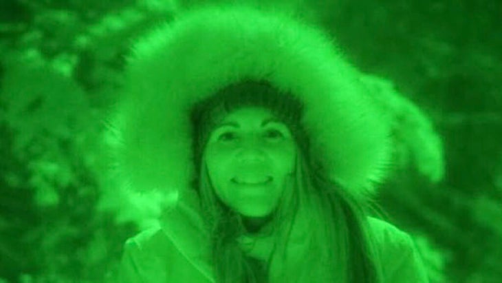 A green night-vision-style image of the author wearing a jacket with a furry hood, taken one night in Minnesota