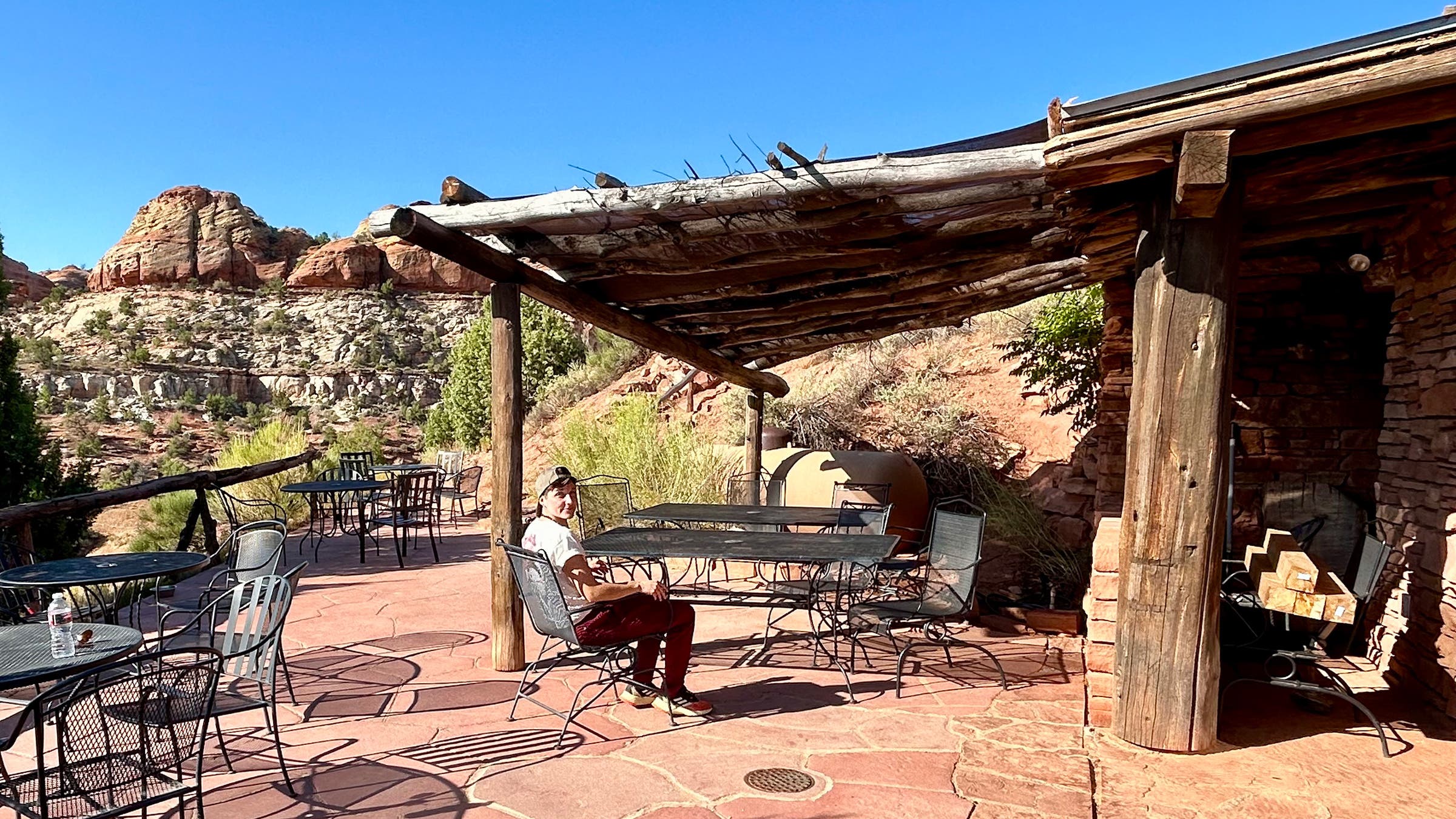 guest sits at Kiva Koffeehouse patio