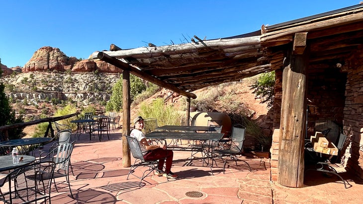 guest sits at Kiva Koffeehouse patio