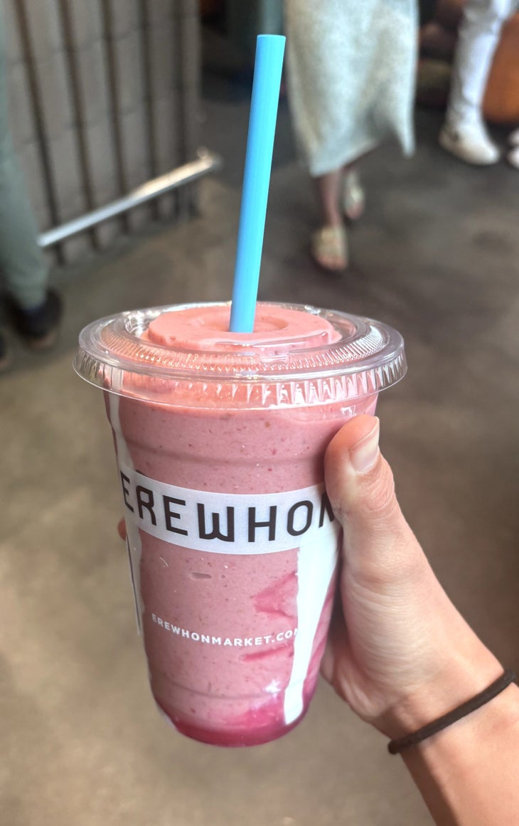 Pink smoothie in hand