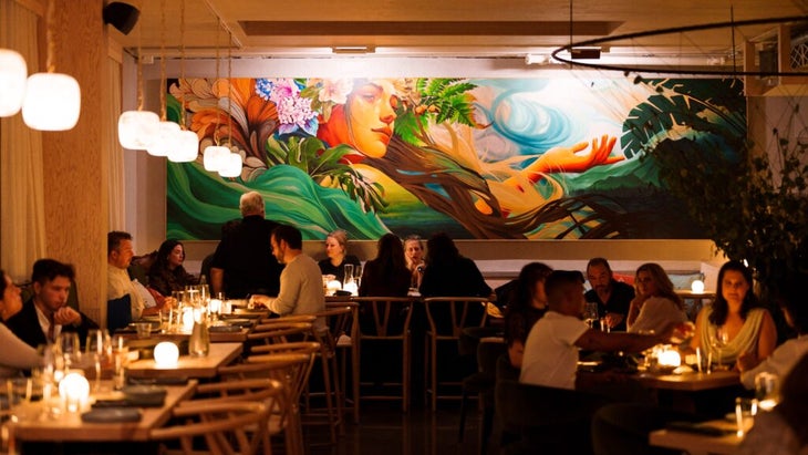 The restaurant at the new Cascada hotel in Portland, Oregon, has a back-wall mural of a woman near the ocean with flowers in her hair.