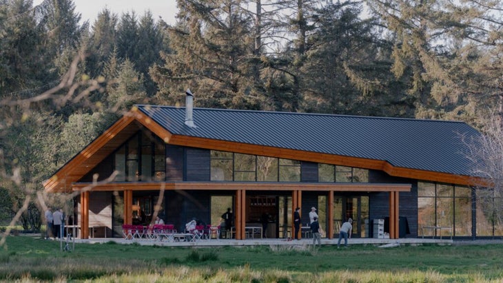 The main lodge of Snow Peaks Campfield, in Washington, is home to a store, cafe, outdoor grills and games like corn hole