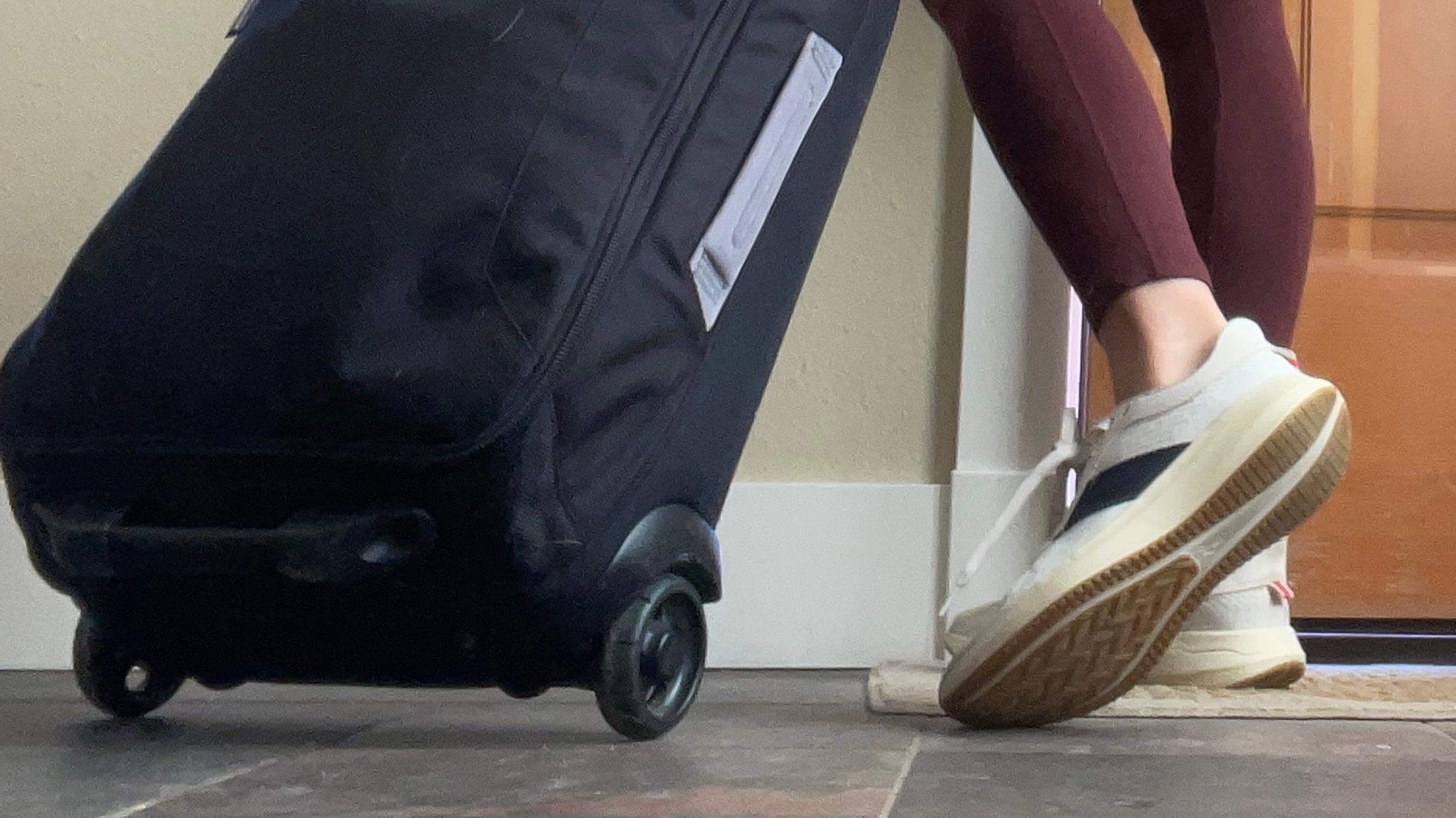 woman wearing versatile running gear with carry-on bag