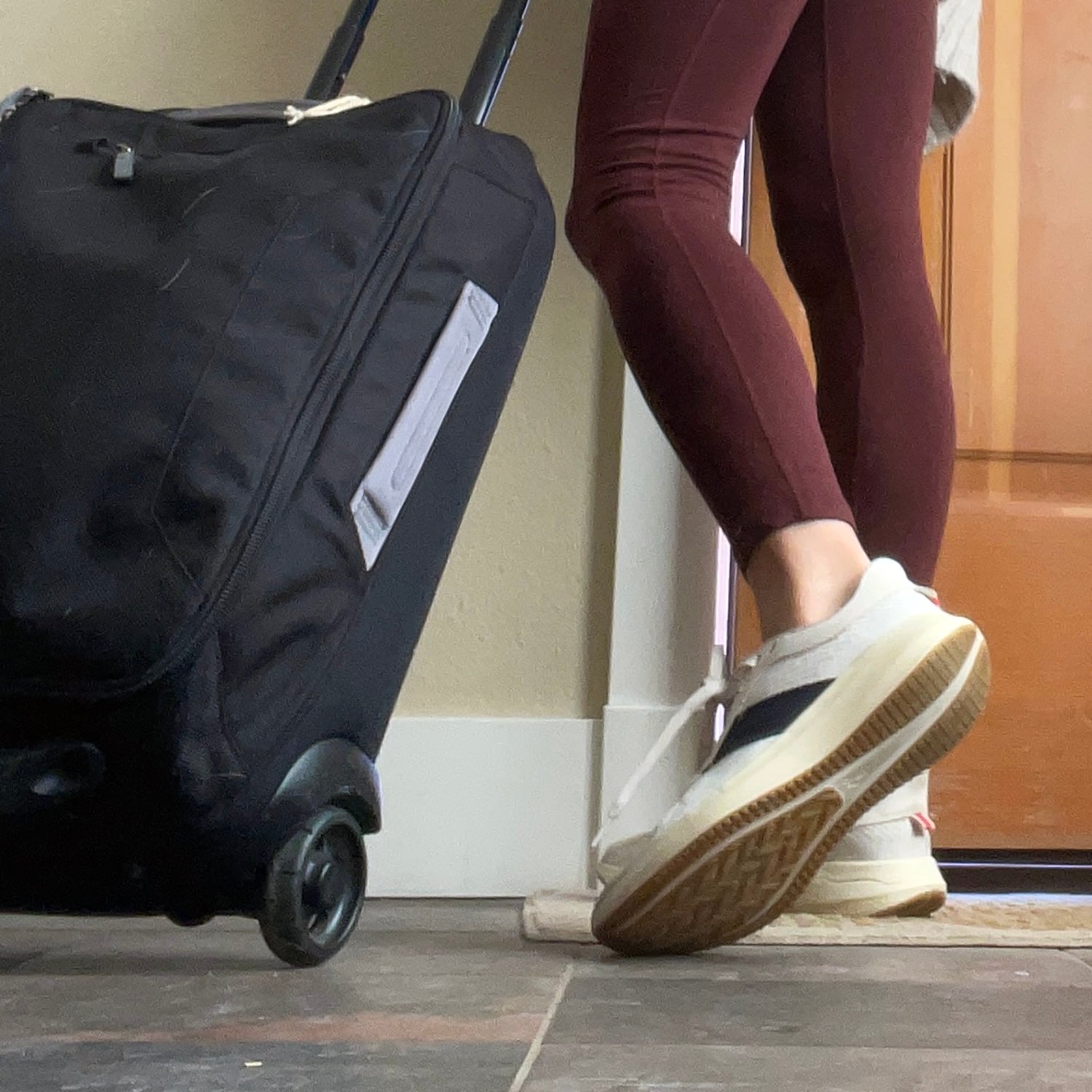 woman in versatile running gear with carry-on bag