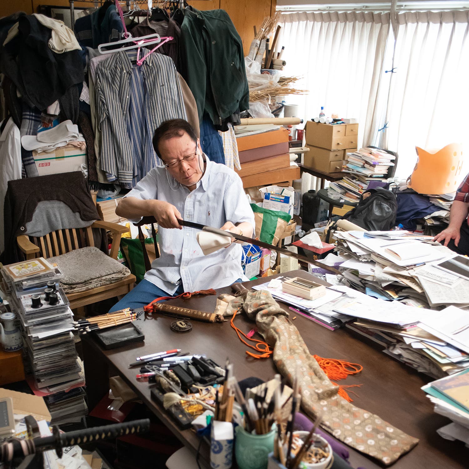 Michihiro Tanobe inspecting the blade on June 26, 2022, in his study in Tokorozawa