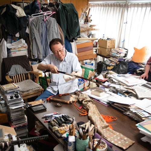 Michihiro Tanobe inspecting the blade on June 26, 2022, in his study in Tokorozawa