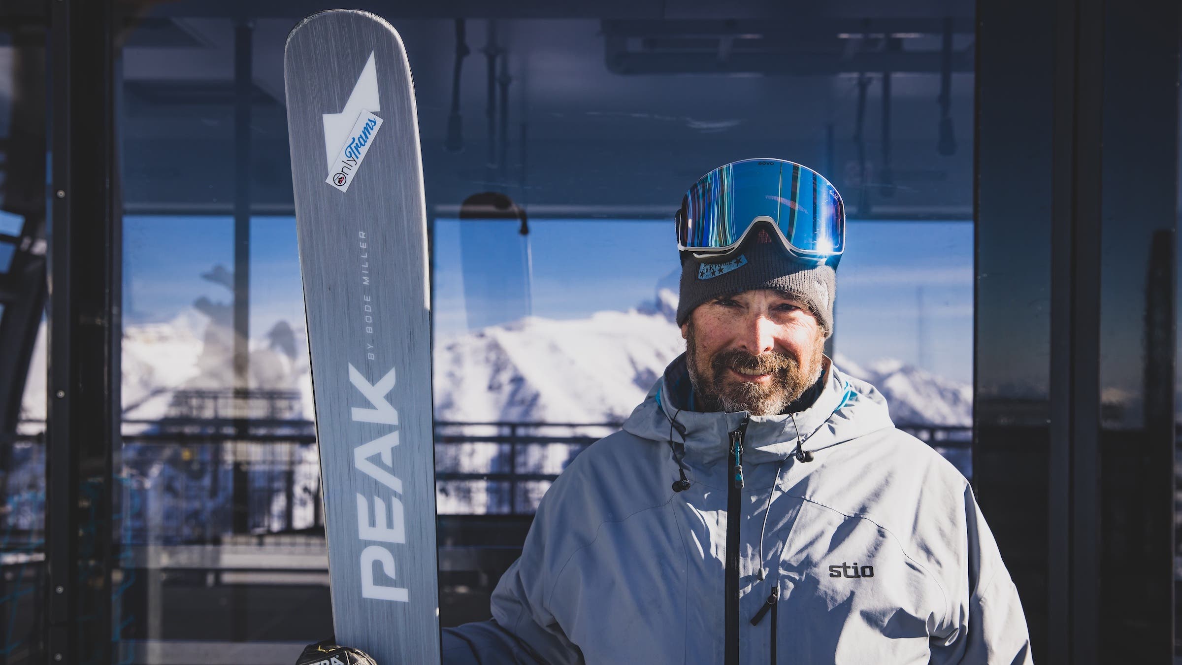 man posing outdoors with skis