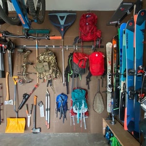Gear displayed on pegboard wall in garage
