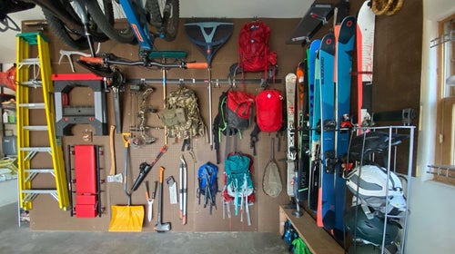Gear displayed on pegboard wall in garage