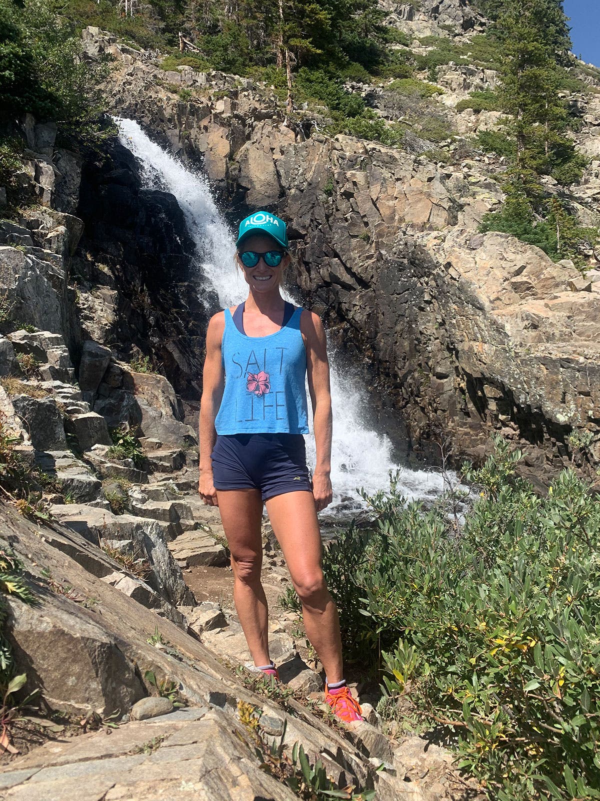 Jen Murphy in front of a waterfall on a hike near Breckenridge, Colorado