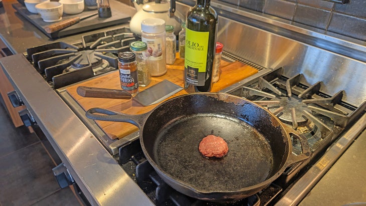 A sausage patty frying