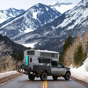 Supertramp Campers Flagship HT camper on truck parked on snowy road to the mountains