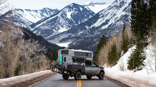 Supertramp Campers Flagship HT camper on truck parked on snowy road to the mountains