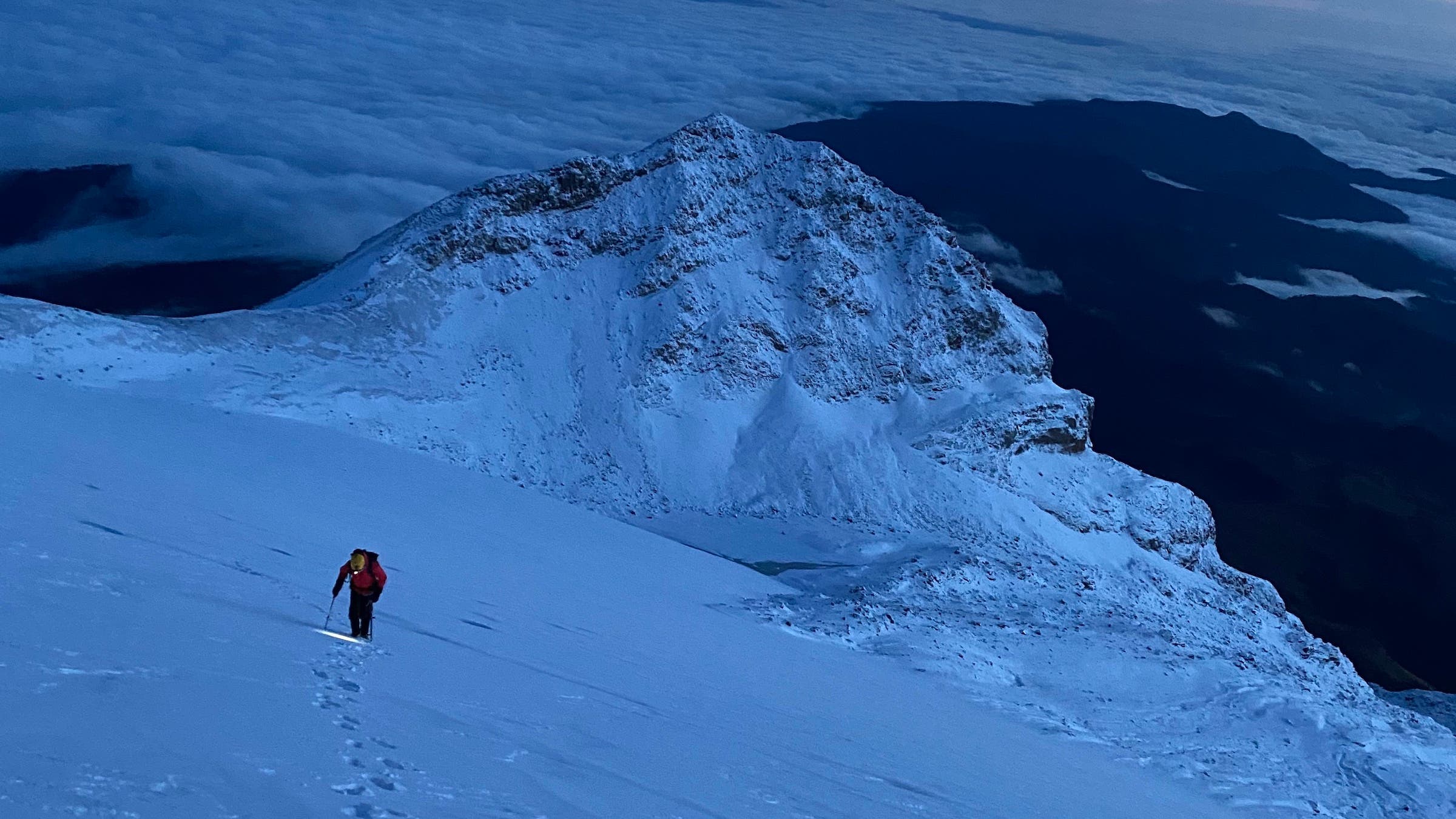 man in snow with headlamp