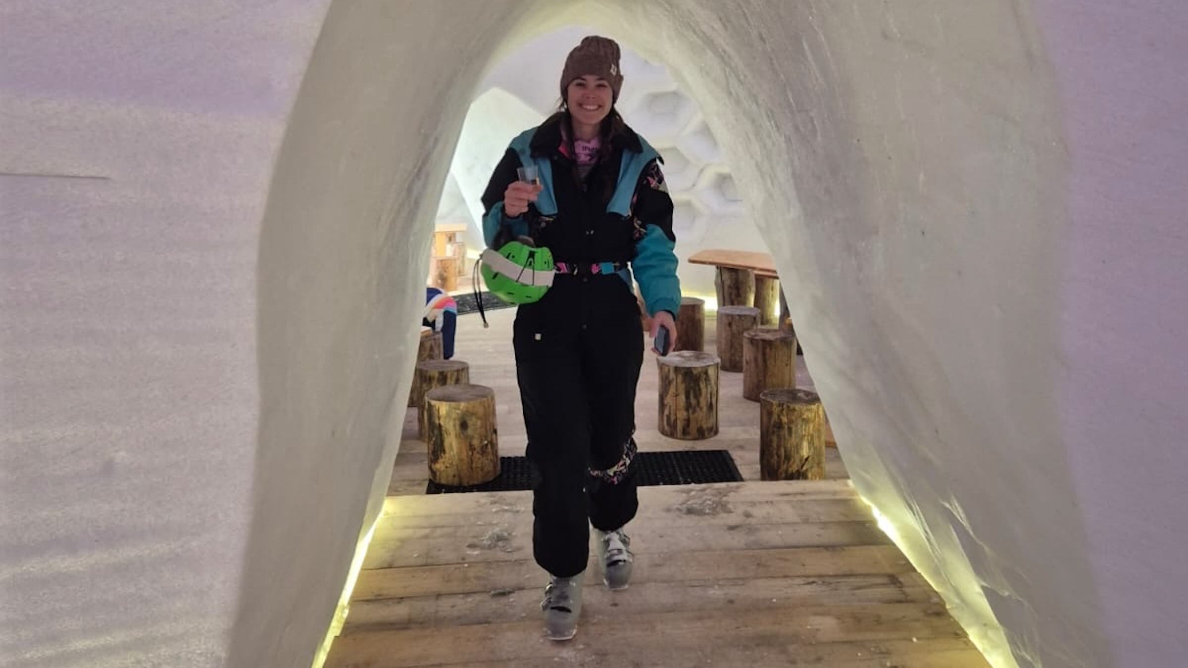 woman walking through snow tunnel in ski gear